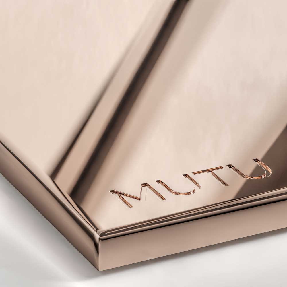 A close-up view of a Polished Rose Gold metal surface, characterized by a bright, reflective mirror finish with distinct pink and copper hues.