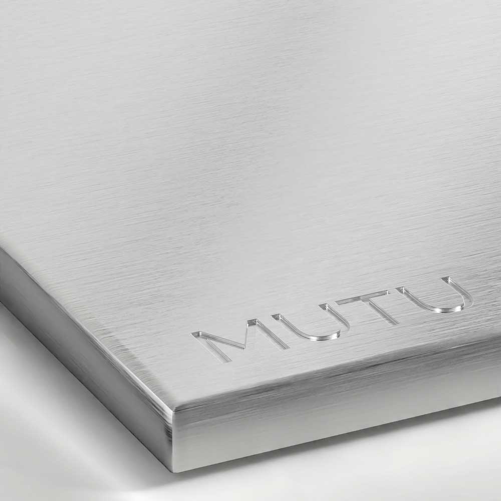 A detailed view of a Brushed Stainless Steel surface, showing a cool silver tone with fine, parallel friction lines creating a soft, satin sheen.