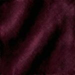 Close-up of Matte Cotton Velvet in Bordeaux Claret, showing a dense, non-reflective pile in a rich wine-red hue with a soft, uniform texture that absorbs light.
