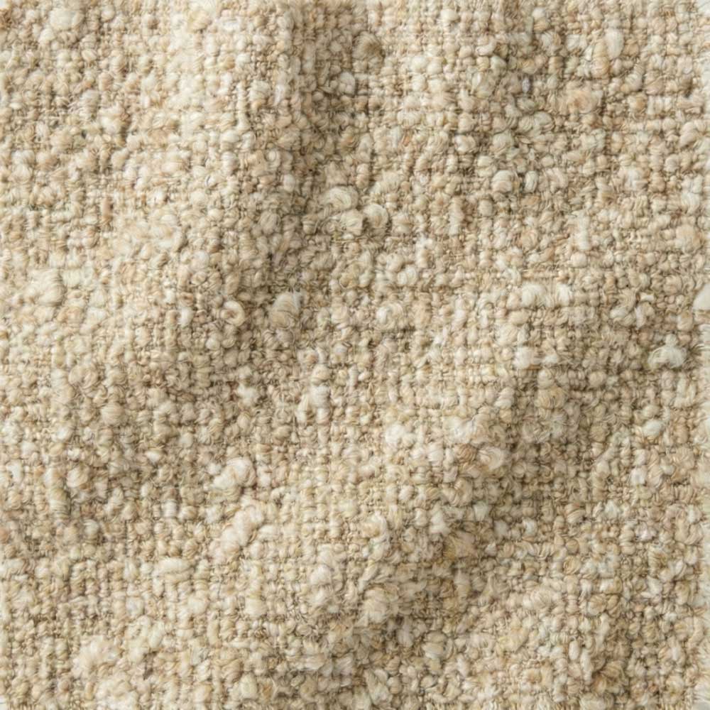 Close-up swatch of Melange Bouclé fabric in Oatmeal, showing a variegated weave of cream and sand-colored knotted loops with a soft, three-dimensional architectural texture.