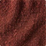 Close-up of Melange Bouclé fabric in Oxblood, featuring a multi-tonal weave of deep red and black knotted loops with a dense, three-dimensional tactile surface.