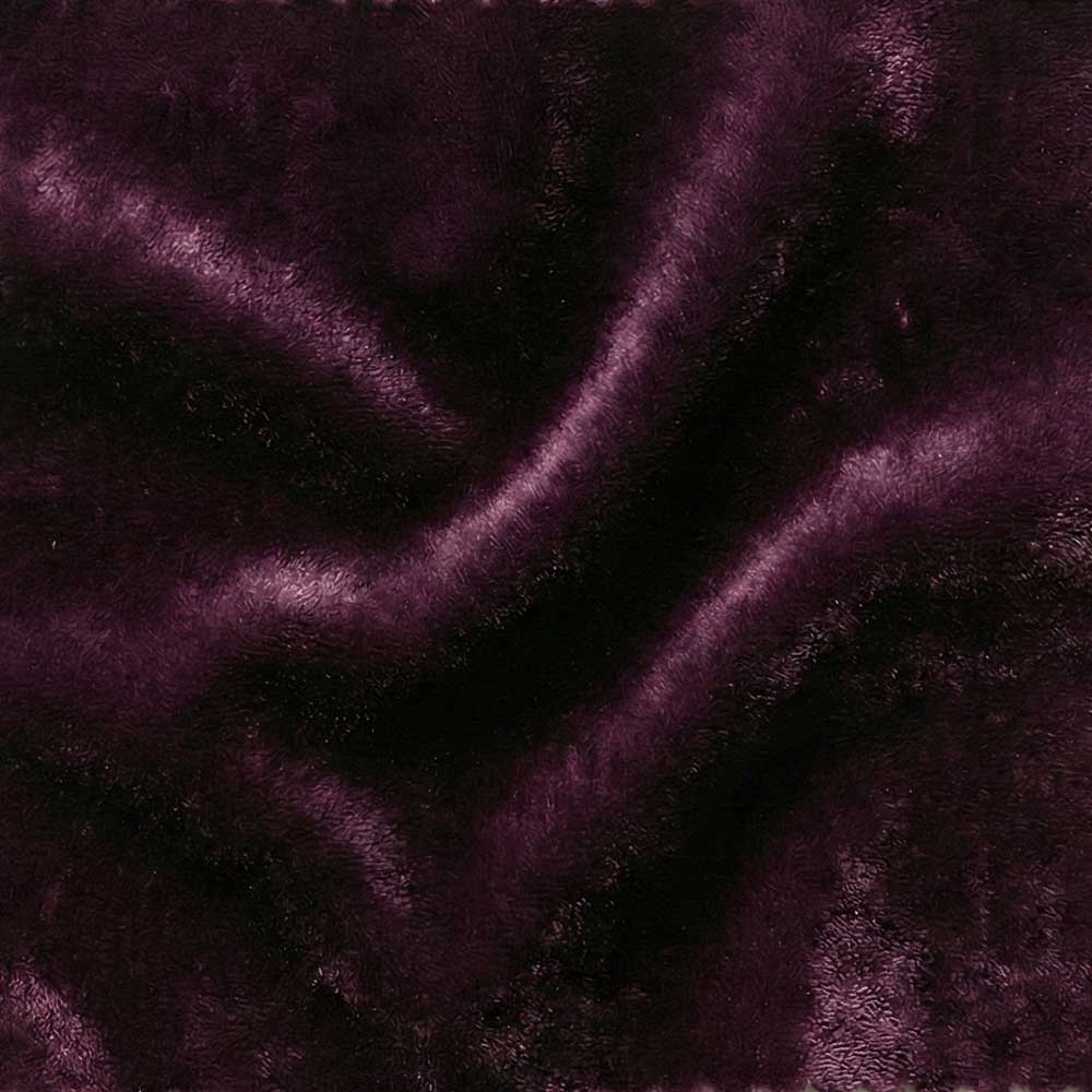 Close-up swatch of Mohair Velvet in Aubergine, showing a dense, silky pile in a deep plum-purple shade with a natural luster that reflects light across the surface.