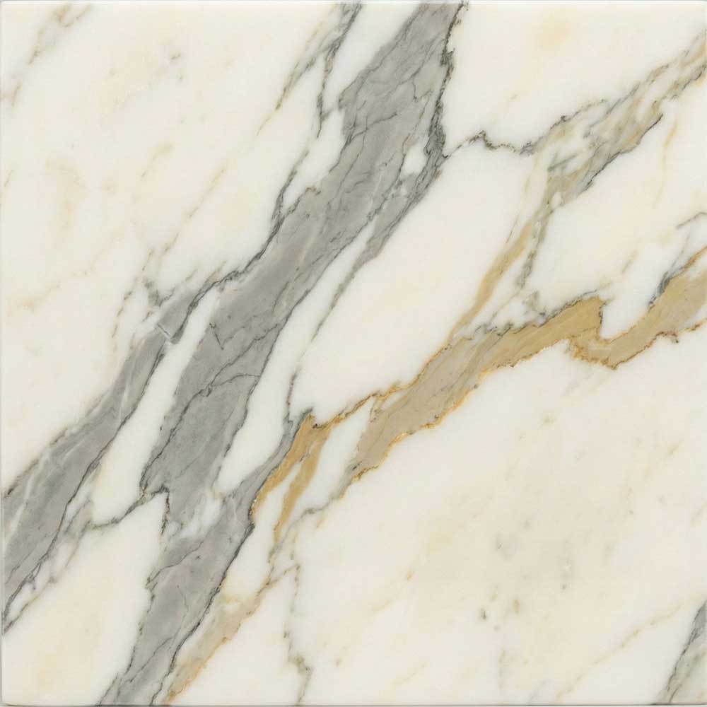 A detailed close-up of a polished Calacatta Gold marble surface, showcasing a warm, milky-white background intersected by thick, wandering veins of soft grey and distinctive ribbons of metallic gold.