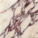 A close-up image of a polished Calacatta Viola marble slab, featuring a classic white background heavily saturated with bold, brecciated veining in rich shades of deep burgundy, wine, and violet.