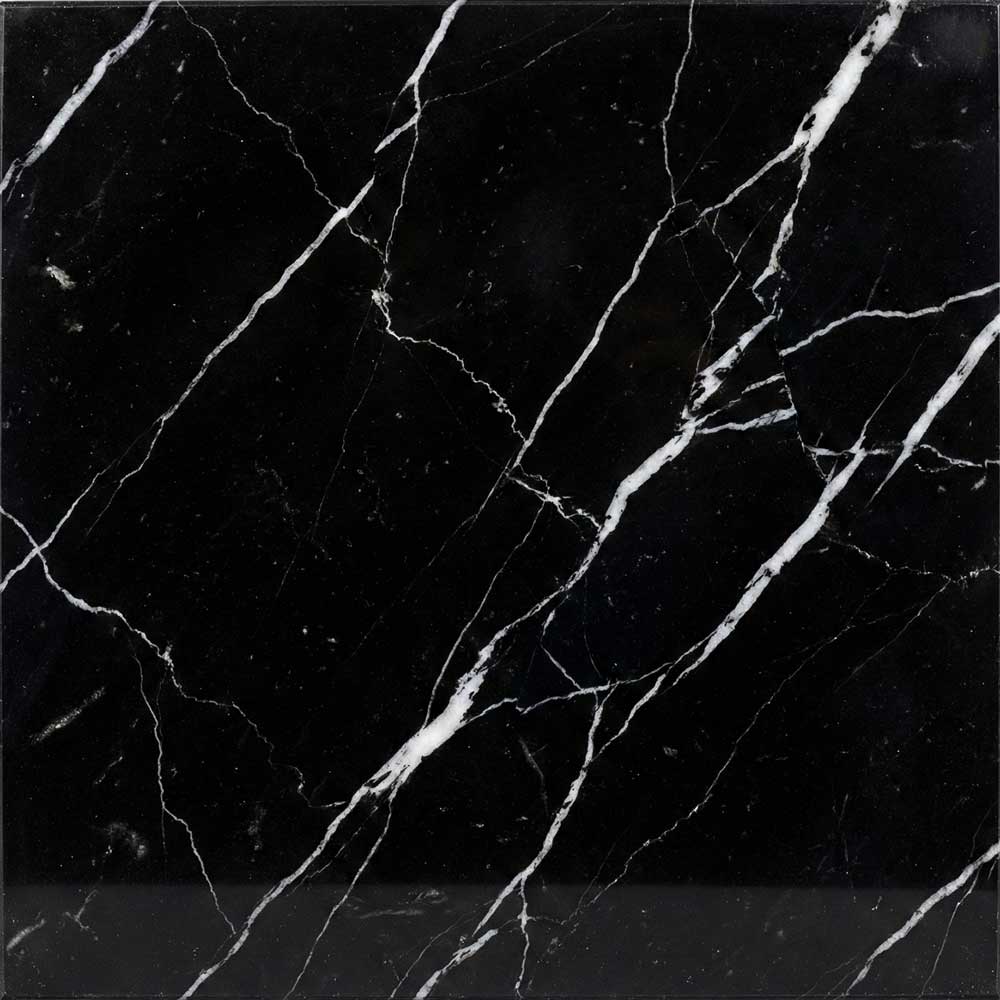 A detailed close-up of a polished Nero Marquina marble surface, featuring an intense, velvety black background struck through with sharp, lightning-like veins of pure white.