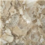 A close-up of a polished Patagonia granite slab, showcasing a dramatic, graphic mix of translucent crystalline quartz, creamy beige fields, and distinct islands of earthy brown and black.