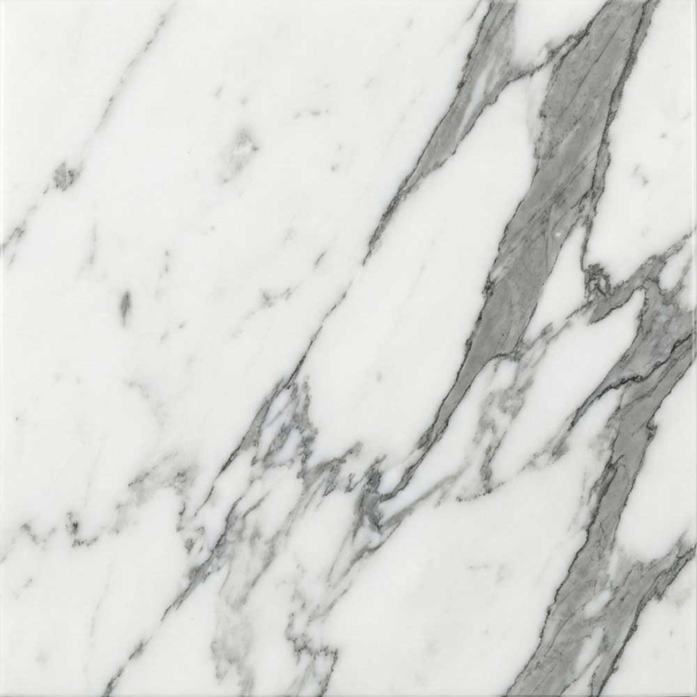 A close-up photograph of a polished Statuario marble slab, showing a bright, luminous white background traversed by bold, sweeping veins of varying shades of cool grey.