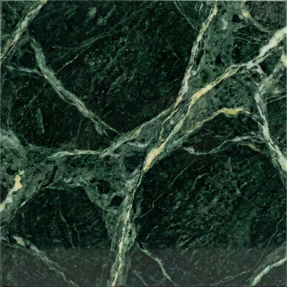 A detailed close-up of a polished Verde Alpi marble surface, featuring an intense dark forest green background swirling with lighter sea-green tones and bright white mineral veins.