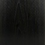 A close-up view of an Ebony Black wood surface, showing a dense, uniformly jet-black tone with very subtle, tight grain lines visible only under direct light.