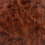 A detailed close-up of a Redwood Burl veneer, showcasing a deep, russet-red background filled with complex, swirling grain patterns and tight clusters of dark knots.